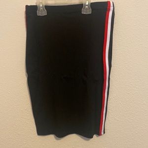 A black pencil skirt with red and white stripes on the side
